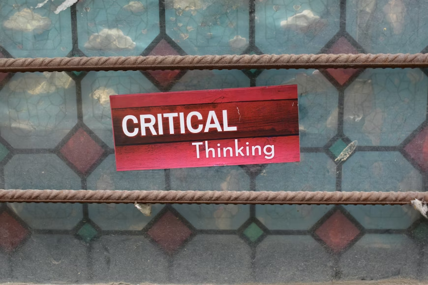 critical thinking skills explained through a concept sign on textured background