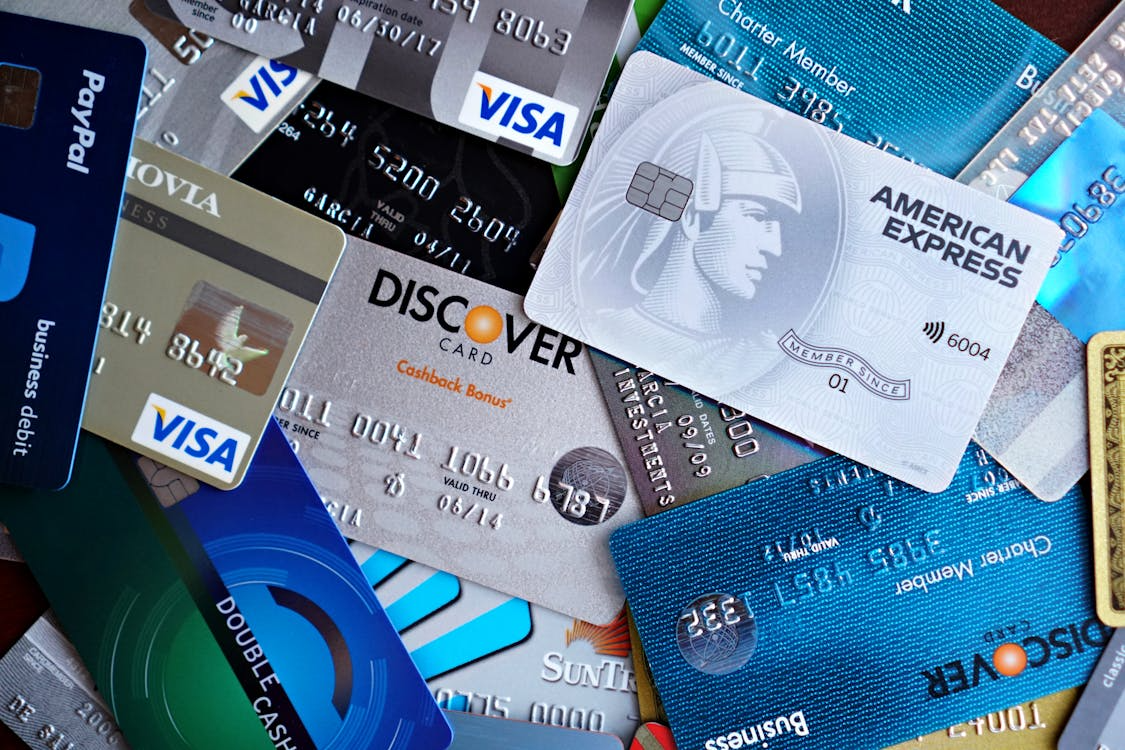 how credit card companies make money through interest fees and transactions