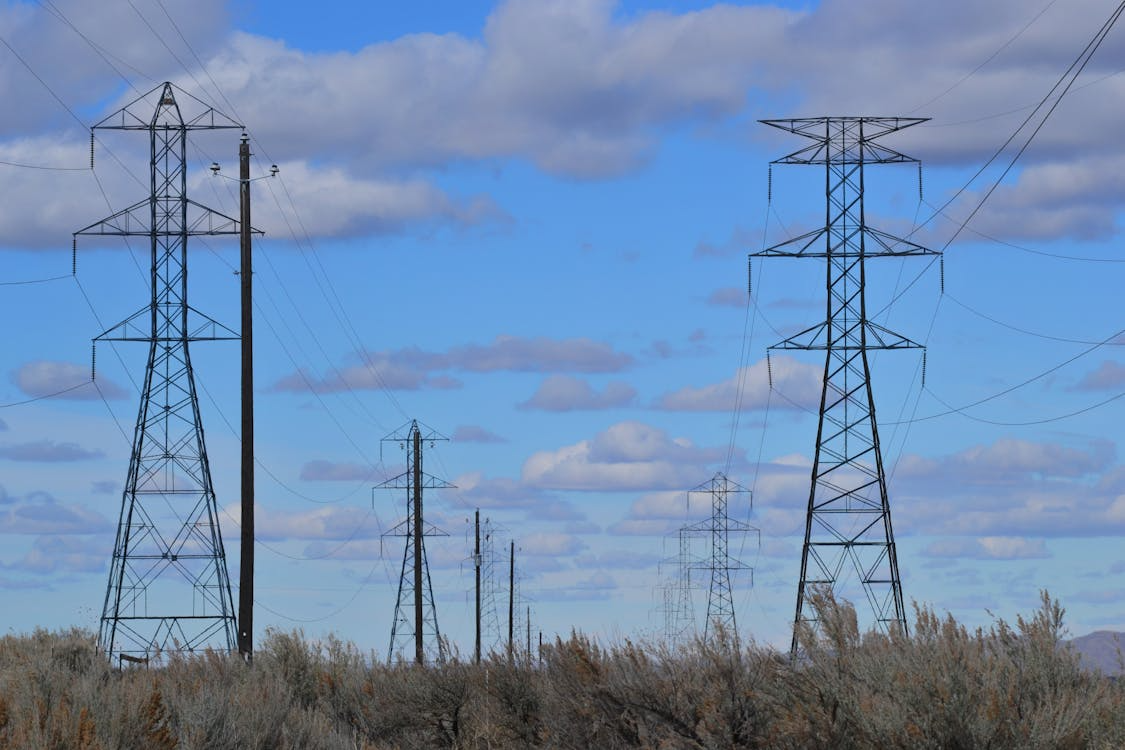 how electric grids work with high voltage transmission lines carrying power across distances
