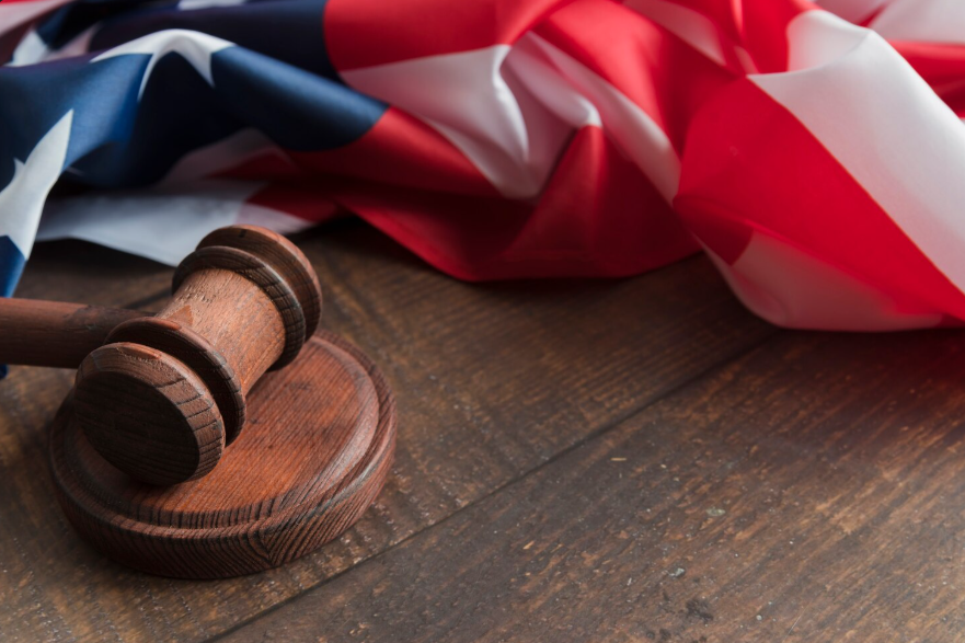 how governments make laws illustrated by a gavel and national flag on table