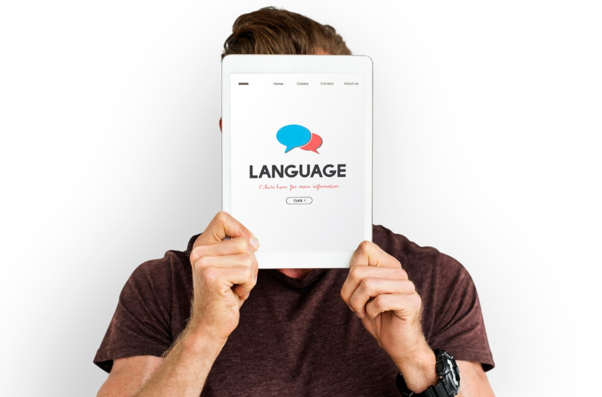 how language shapes reality illustrated by a person holding a tablet with language symbol